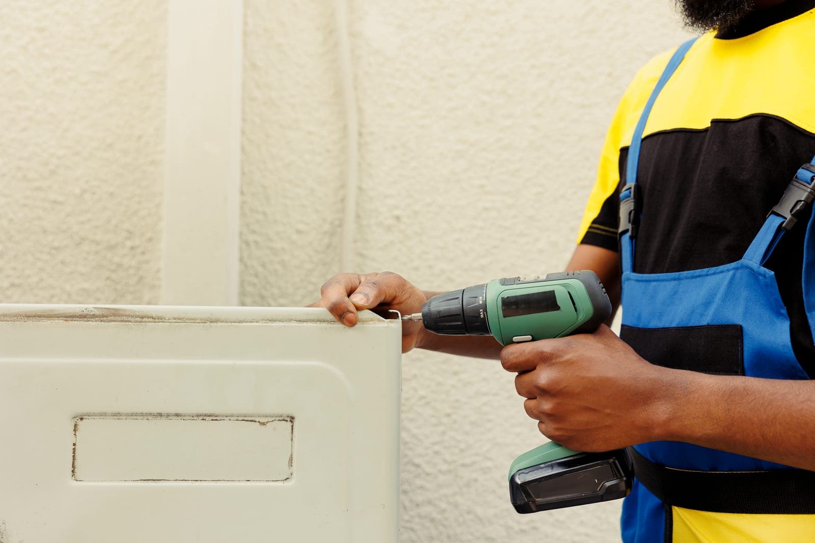 A handyworker installing an air conditioner